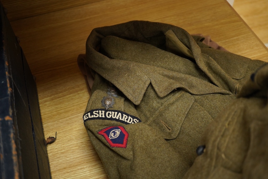 A WWII Welsh Guard’s uniform, comprising a dress jacket, two dress blouses, one with label stating 1940 Pattern Size No.6, breast 38” to 39”, waist 33” to 34”, a pair of breeches, a pair of trousers and a tie, together w